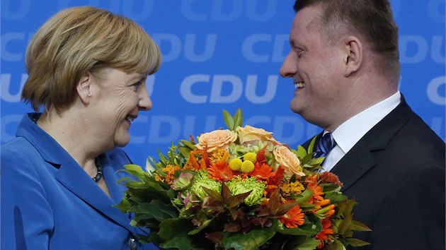 Kancléřka Angela Merkelová a Hermann Gröhe, generální tajemník Křesťanskodemokratické unie (CDU) po zveřejnění prvních výsledků, které naznačují jejich výhru v parlamentních volbách. (22. 9. 2013)
