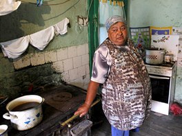 Pensioner Maria Draguta, 59, an ex-miner, poses for a photograph in her house...