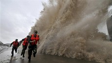 Vojáci ve Wen-lingu utíkají p�ed vlnou, kterou na pob�e�í mr�til tajfun Fitow....