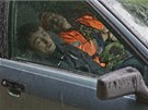 Migrant workers sleep in a car in the village of Krasnaya Polyana, a venue for...