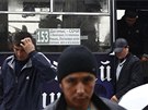 Migrant workers exit a bus after being detained in a sweep by authorities at a...