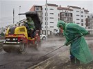 Workers lay asphalt in the Olympic Park in the Adler district of Sochi