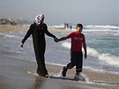 Newly married Tala Soboh, 14, and her 15-year-old husband Ahmed walk on the...
