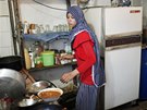 Newlywed Tala Soboh, 14, washes dishes at the home of her 15-year-old husband...