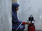 Newly married Tala Soboh, 14, prepares tea at the home of her 15-year-old...