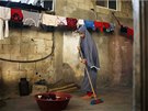 Newly married Tala Soboh, 14, sweeps the house of her 15-year-old husband...