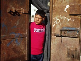 Newly married Ahmed Soboh, 15, looks out of his family house two days after his...