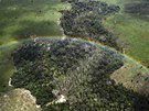 A rainbow is seen over a tract of Amazon rainforest which has been cleared by...