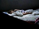 A girl sleeps in her home, which stands alongside the Trans-Amazonian highway,...