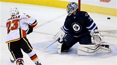 Sean Monahan z Calgary pekonává z nájezdu Ala Montoyu, brankáe Winnipegu.