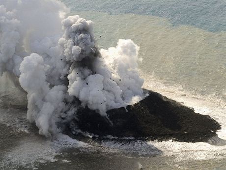 Smoke from an erupting undersea volcano forms a new island off the coast of...