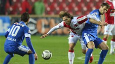 ZA MÍEM.  Mario Lika ze Slavie se pokouí proklouznout mezi Michael Rabuicem