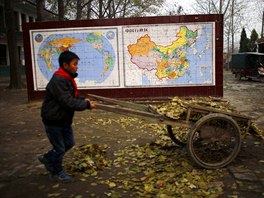 A student collects leaves at the Democracy Elementary and Middle School in...