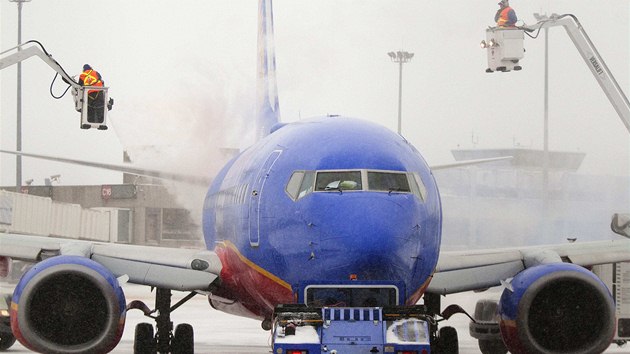 Pracovnci letit v Bostonu rozmrazuj letadlo bhem snhov boue, kter zashla severovchod USA (2. ledna 2014).