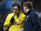 Záloník Tomá Rosický z Arsenalu opoutí hit se zkrváceným nosem.