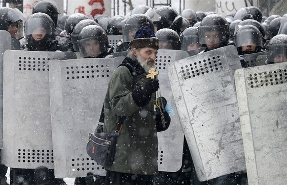 Pravoslavný knz prochází kolem policejního kordonu ve stedu Kyjeva. (22....