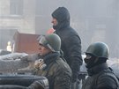 Prostestující hlídkují na jedné z barikád v centru Kyjeva. (24. ledna 2014)