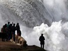 Lidé pozorují obrovské vlny, které se títí o pobeí u portugalského Nazaré...