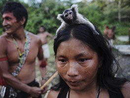 A Munduruku Indian woman warrior carries a monkey on her head in western Para...