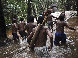 Munduruku Indian warriors approach a gold mine as they search for illegal gold...