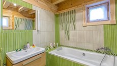 Koupelnu si nechali manelé obloit keramickými obklady ve veselé zelené barv.
