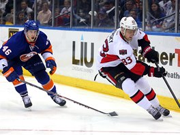 Matt Donovan z NY Islanders sleduje kouzla Alee Hemskho z Ottawy.
