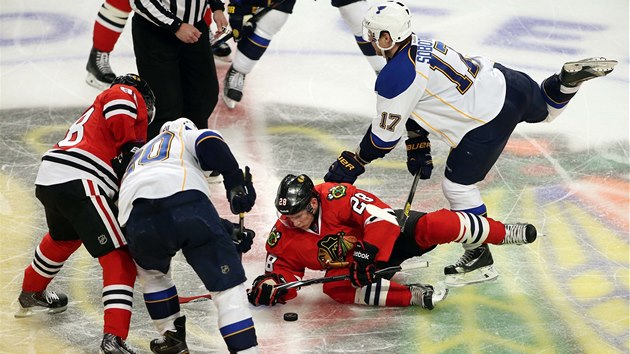 BOJ.  Lec Ben Smith a Patrick Kane z Chicaga se rvou o puk s dvojic Alexander Steen, Vladimr Sobotka (vpravo) ze St. Louis.