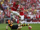 PESKOÍM T. Aaron Ramsey z Arsenalu (nahoe) se skluzem Davida Meylera z...