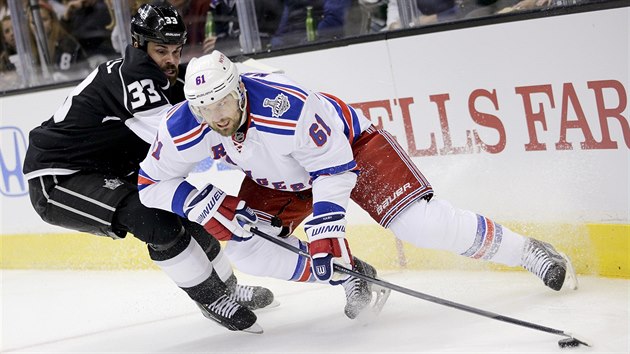 Rick Nash (vpravo) z NY Rangers unik kolem Willieho Mitchella z Los Angeles.