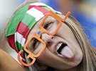 An Italian fan makes a face as she poses before the start of the group D World...