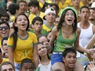 Brazilian soccer fans react while watching the opening soccer match between...