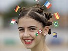 A fan donning miniature national flags representing Italy, Germany, Mexico,...