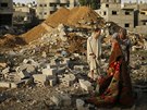 Palestinci stojí mezi troskami domu, který byl znien izraelským náletem na...