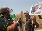 Palestintí demonstranti drí fotografie obtí izraelských nálet a dohadují se...