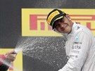 TO JE ZA NIKA. Lewis Hamilton schytává sprkou sektu na stupních vítz v...