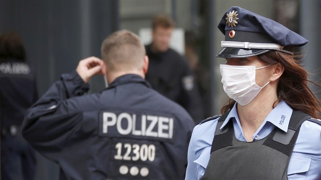Nmet policist v ochrannch roukch stoj ped uzavenm adem prce v berlnskm mstskm obvod Pankow. (19. srpna 2014)