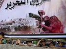 Palestinské dti se koukají pod plakátem podporující palestinská hnutí v Rafáhu...