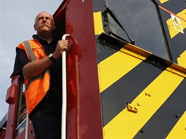 Strojvedoucí nákladního vlaku Chris Bingham pózuje fotografovi nedaleko...