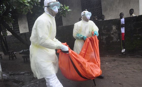 Zdravotníci v liberijské Monrovii odnáejí tlo eny, která zemela na ebolu ...