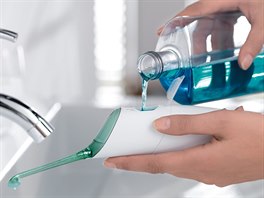 Přístroj AirFloss s nádržkou na ústní vodu a s hlavicí, která vstřikuje ústní...