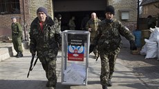 Ozbrojenci penáejí volební urnu k provizornímu hlasovacímu místo nedaleko...