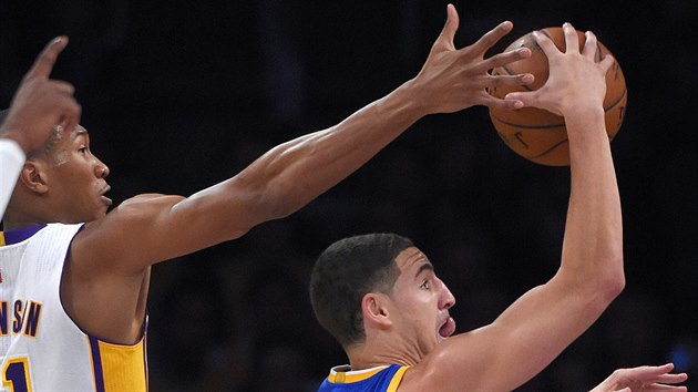 Klay Thompson (vpravo) z Golden State se pokou zakonit, o blok se sna Wesley Johnson z LA Lakers.