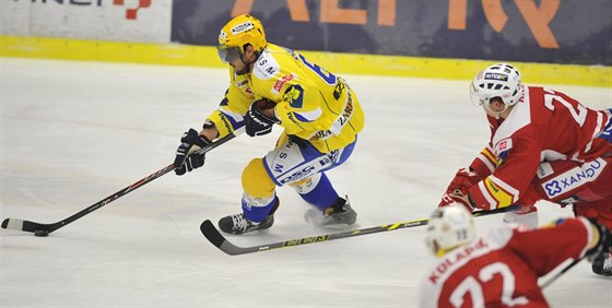 Zlinský hokejista Jakub Svoboda   ujídí Danielu Krejímu (vlevo) a Pavlu...