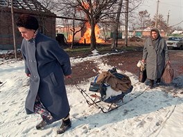 4 Two Russian women flee Grozny on January 21, 1995 carrying their belongings...