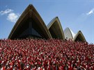 Thousands of runners in Father Christmas suits pose for a group photo after...