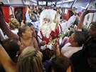 A man dressed as Santa Claus rides a crowded subway train in Sao Paulo,...