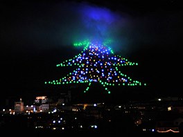 Lights form the outline of a Christmas tree on the slope of Mount Ingino,...