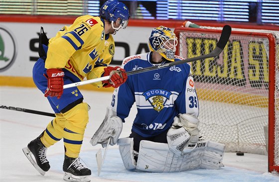 védský hokejista Martin Johansson pekonává finského brankáe Atte Engrena.