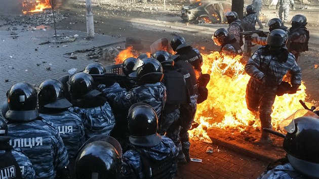 Ukrajinští policisté po zásahu molotovovým koktejlem na kyjevském Majdanu. (18. února 2014)