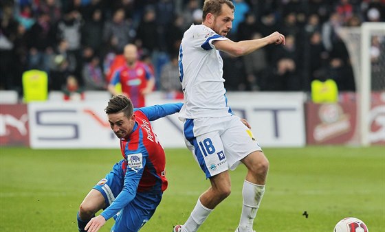 Plzeský fotbalista Milan Petrela padá po souboji libereckým Janem Mudrou.